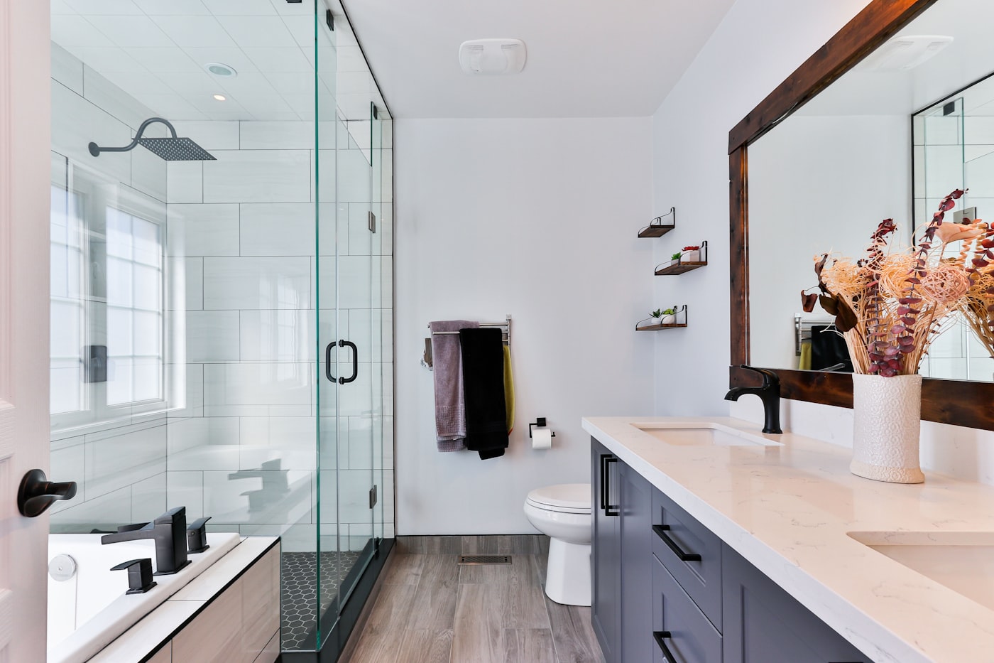 Remodeled bathroom with glass shower, subway tile and a floating vanity